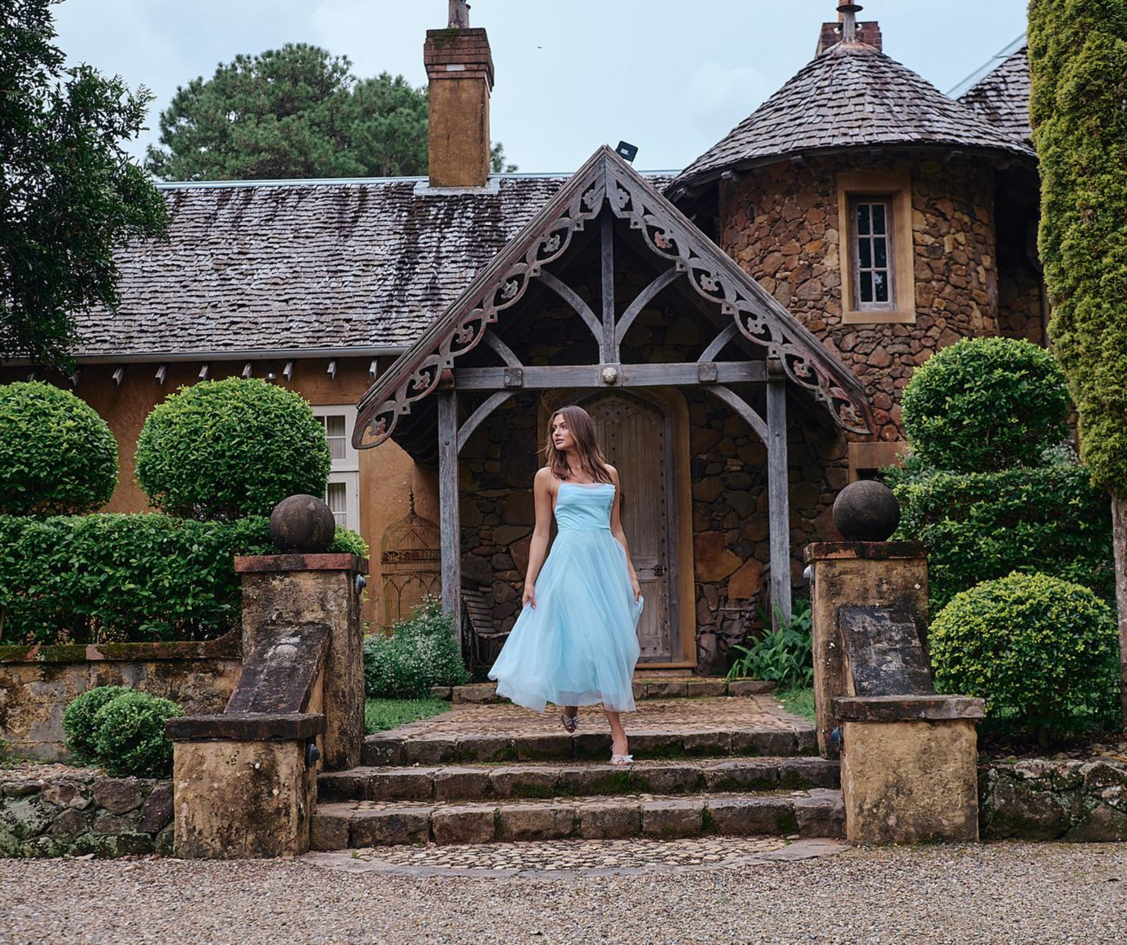 Model wearing soft, flowy clothing from the Wonderland Collection by Nine Muses. Feminine silhouette with elegant, romantic styling in a minimal setting.