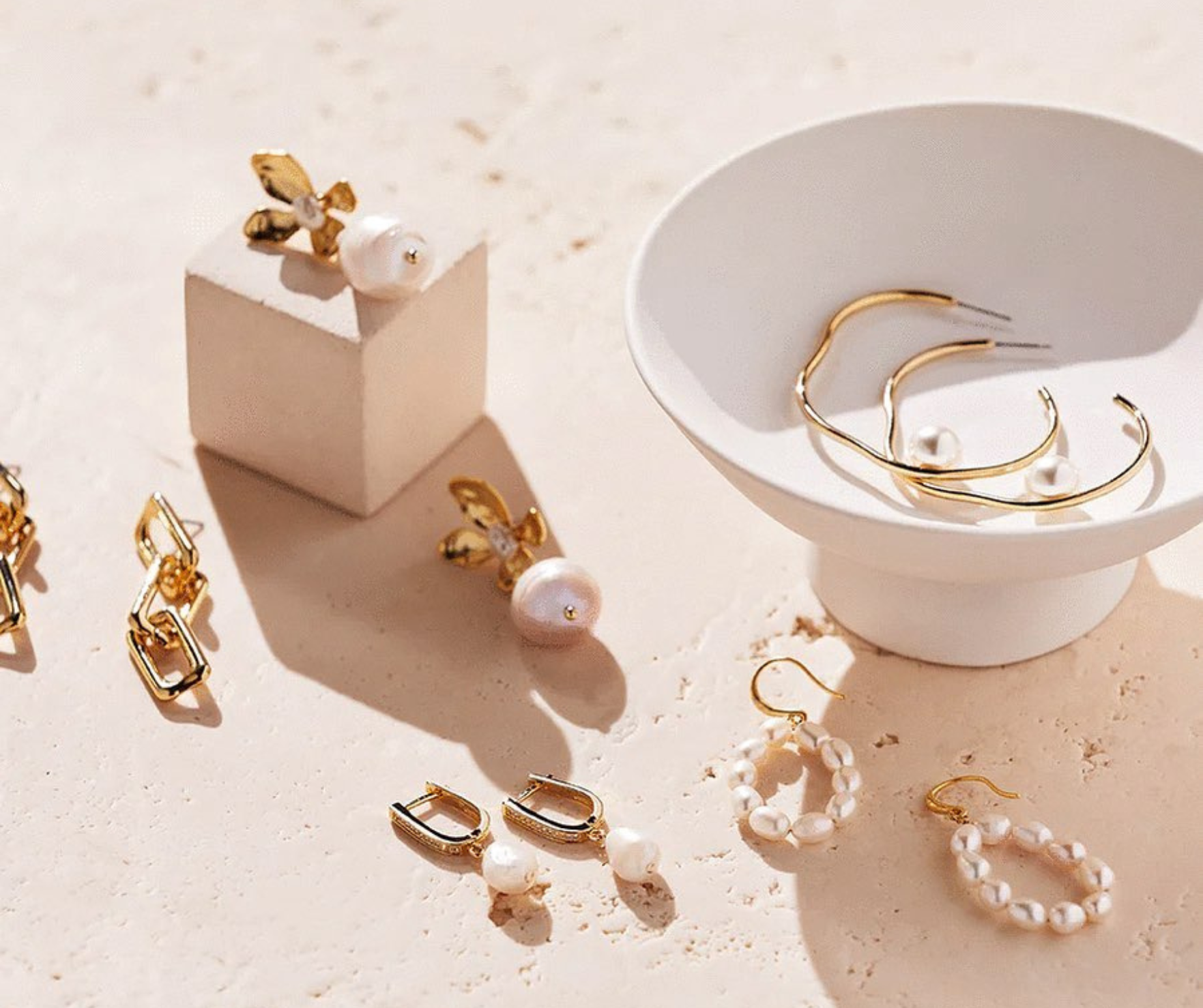 Flat lay of Nine Muses accessories including gold jewelry, heels, and headbands