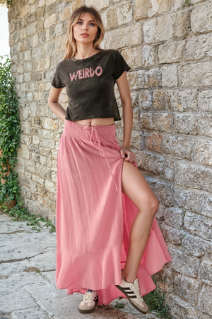 Mineral-washed cropped graphic t-shirt with vintage-style "Weirdo" text print. Features short sleeves, lettuce-edge cuffs and hem, and a relaxed fit. Made from 100% cotton.
